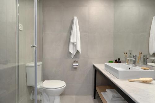 a bathroom with a toilet and a sink and a shower at PERLA TUI SUNEO Adults only Hotel in Sunny Beach