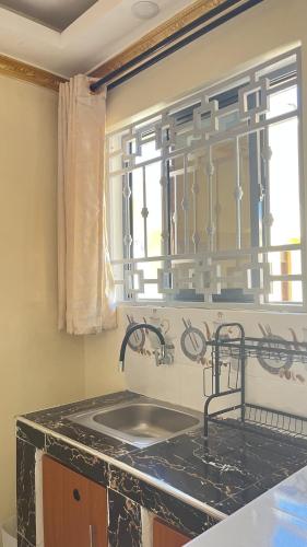 a kitchen with a sink and a window at Westwood Homes in Kilifi