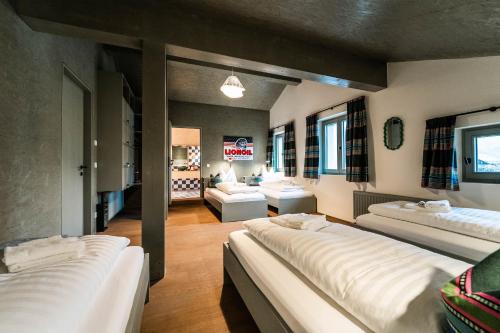 a large room with three beds and a couch at FAT Mankei in Seidlwinkl
