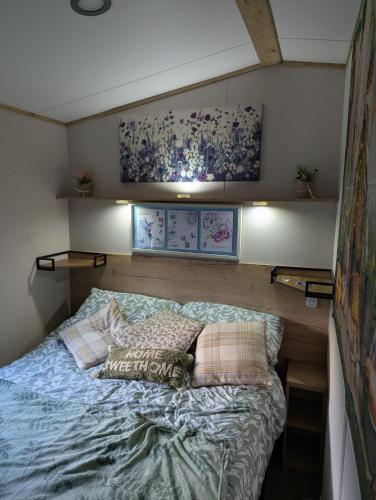 a bedroom with a bed with pillows on it at Arnside abode in Morecambe