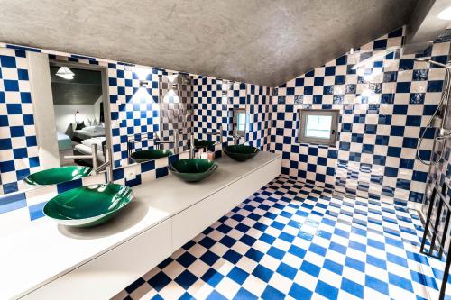 a bathroom with two green sinks and a checkered floor at FAT Mankei in Seidlwinkl