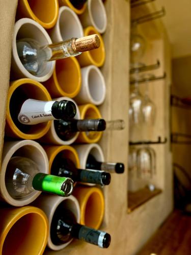 a drawer full of wine glasses and wine bottles at Apartamentos Flores playa in La Mata