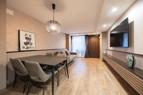 a living room with a table and a couch at The Mita Villa - 2 bed rooms & 3 floors villa with roof garden in Tokyo