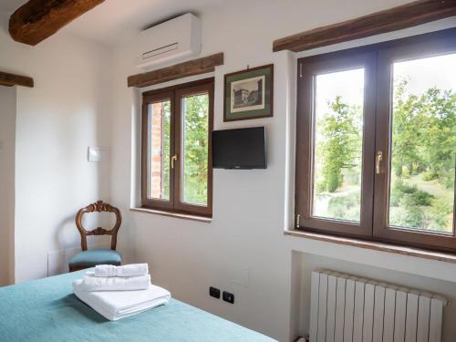 a bedroom with a blue bed and a window at Città della Pieve Retreat in Città della Pieve