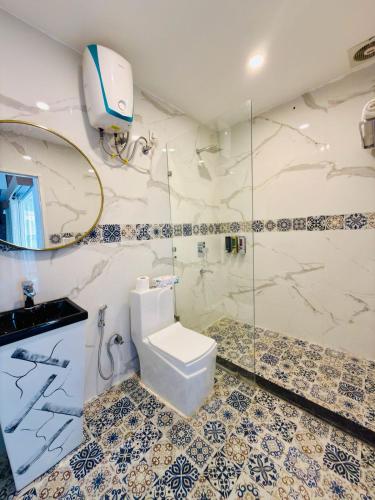 a bathroom with a toilet and a shower at Sundown Resort in Noida