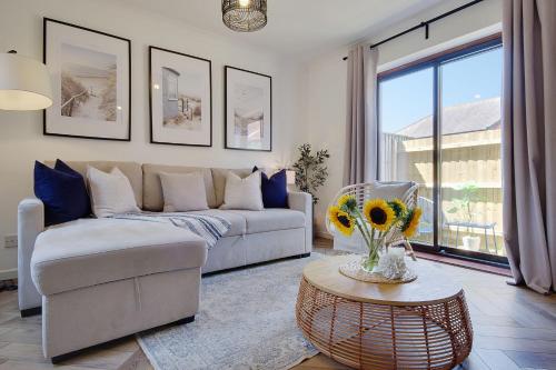 a living room with a couch and a table at The Nook - Cosy coastal retreat near Sandbanks in Poole