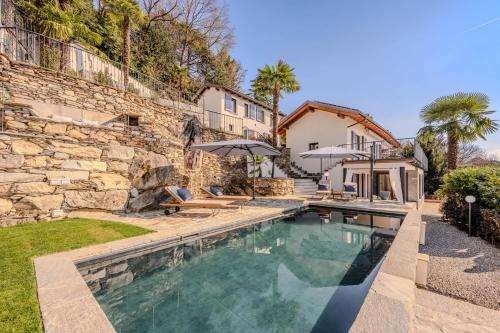a swimming pool in the backyard of a house at Villa Suna Paradiso in Verbania