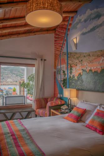 a bedroom with a bed and a living room at Tocuyeros Boutique Hotel in Cusco