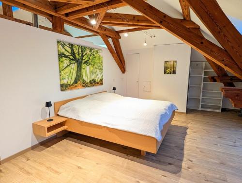 a bedroom with a bed and a painting on the wall at Loft in Weiler in Weiler