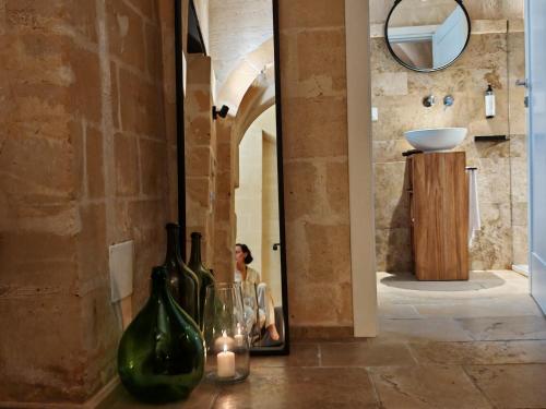 a room with a mirror and some bottles on a table at Dimore dei Mercanti in Matera