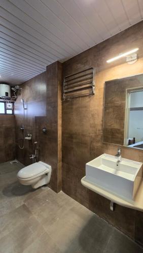 a bathroom with a sink and a toilet at M Beach Resort in Colva