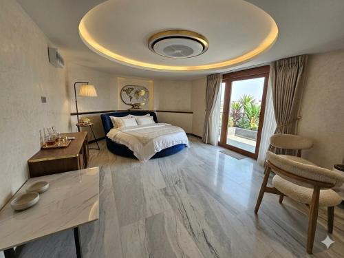 a hotel room with a bed and a table and a room at The Lakeside Sanctuary in Ban Mae Cho