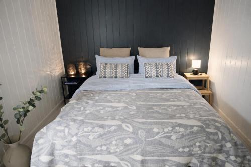 a bedroom with a large bed with pillows at Senja Sjøtun House in Senja