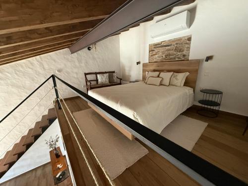 a bedroom with a large bed and a staircase at Casa Rama D Oliveira in Barrada