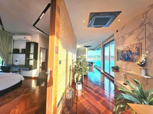 a bedroom with a bed and a view of the water at The Lakeside Sanctuary in Ban Mae Cho