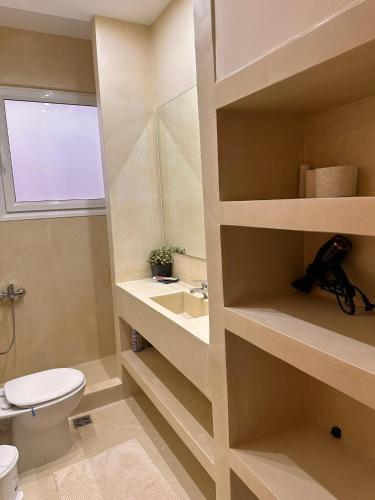 a bathroom with a toilet and a sink at PH Marina Apartments in Porto Heli