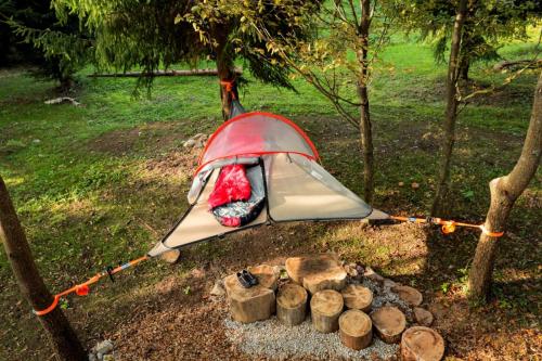 a tent is set up next to a camp fire at Robinzonski kamp Žumberak in Grabar
