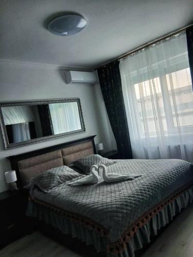 a bedroom with a bed with a towel on it at Apartament Premium Militari Parcare Self Check-in in Roşu