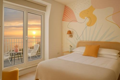 a bedroom with a bed and a view of a balcony at Beach House in Scarborough