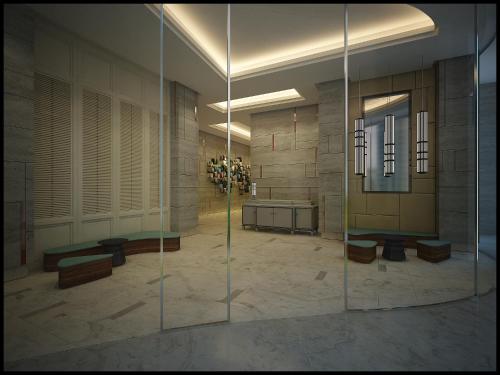 a large lobby with a glass wall in a building at Amari Johor Bahru in Johor Bahru