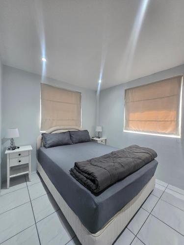 a bedroom with a large bed and a window at Pool Villa 25 in Ban Nong Pru