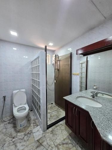 a bathroom with a toilet and a sink and a shower at Pool Villa 25 in Ban Nong Pru