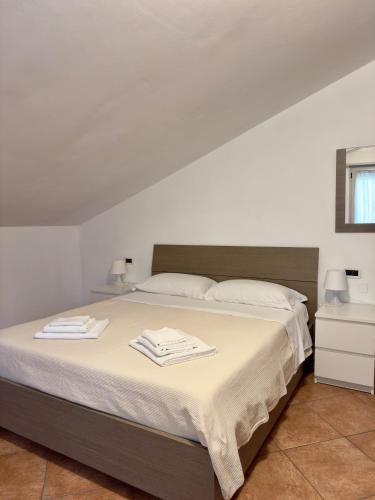 a bedroom with a bed with two towels on it at Sole & Mare in Montesilvano