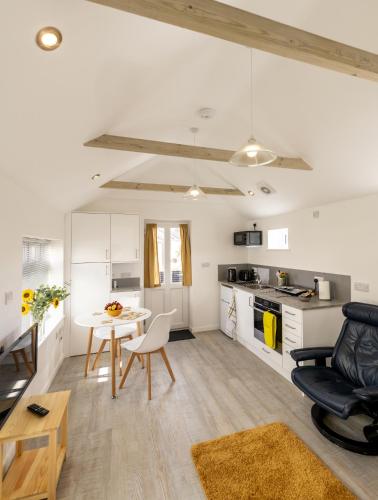 a kitchen and living room with a table and chairs at The Bake House in Worthing