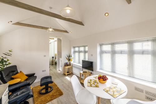 a living room with a table and a couch at The Bake House in Worthing