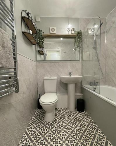 a bathroom with a toilet and a sink at Seaways Apartment in Worthing