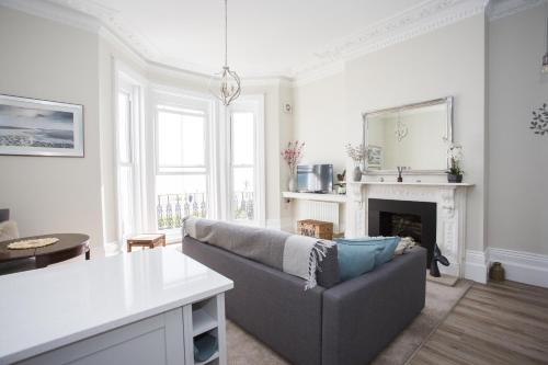 a living room with a couch and a fireplace at Seaways Apartment in Worthing