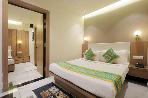 a hotel room with a large bed and a mirror at Taj Inn Hotel in Agra