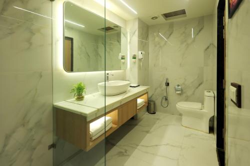 a bathroom with a sink and a toilet at Taj Inn Hotel in Agra