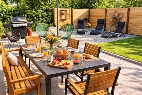 a picnic table with food and drinks on a patio at Ferienhaus Haus im Garten in Feldkirch