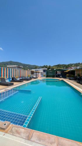 a large swimming pool with blue water at Diamond Crown Patong in Patong Beach
