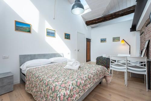 a bedroom with a bed and a table and chairs at Stay Bergamo Centro in Bergamo