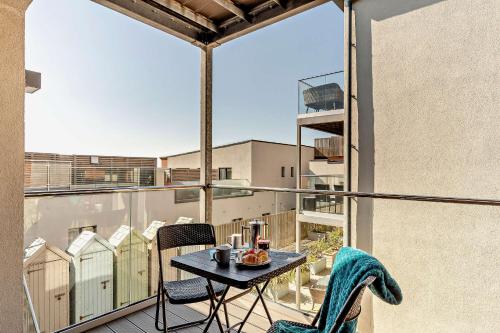 a balcony with a table and chairs on a balcony at 8 Putsborough - Luxury Apartment at Byron Woolacombe, only 4 minute walk to Woolacombe Beach! in Woolacombe