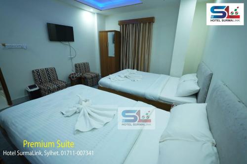a hotel room with two beds and a tv at Hotel SurmaLink in Sylhet
