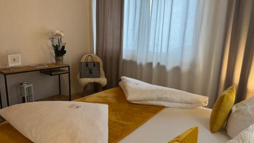 a bedroom with a bed and a desk and a window at Apartment Alpen Lodge 52 in Aschau