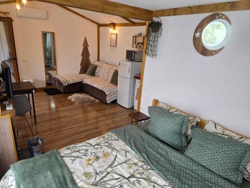 a living room with a couch and a living room with a couch at Cabana Mura in Olăneşti