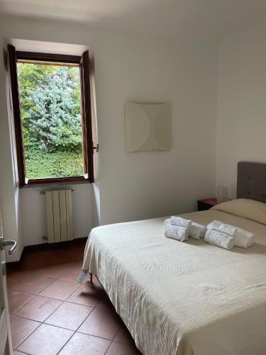 a bedroom with two beds and a window at Lakefront holiday in Salò
