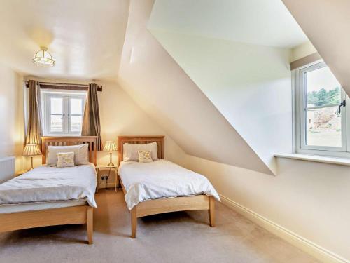 a attic bedroom with two beds and a window at 2 Bed in Nottingham oc-47032 in Besthorpe