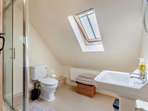 a bathroom with a toilet and a sink and a window at 2 Bed in Nottingham oc-47032 in Besthorpe