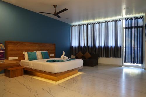 a bedroom with a bed and a ceiling fan at Mount Minar Munnar in Anachal