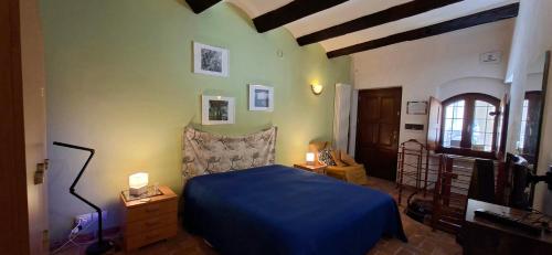 a bedroom with a blue bed in a room at La Marmotta in Luserna San Giovanni