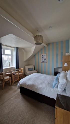 a hotel room with a bed and a table at Black Sheep Lodge in Holyhead