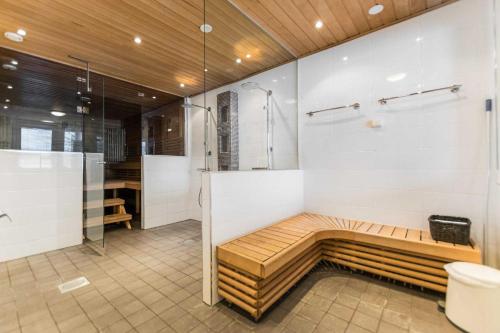 a bathroom with a shower and a bench in it at Päijänteen Helmi 1 in Jämsä
