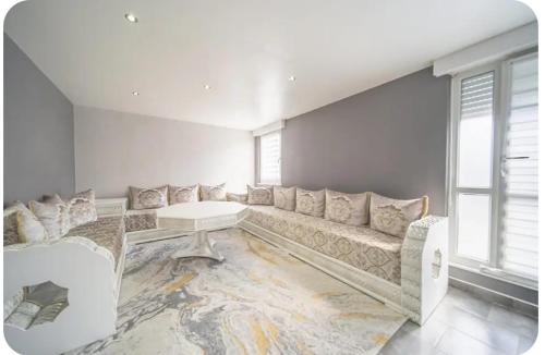 a large living room with a couch and a table at Chez moi in Mont-Saint-Martin