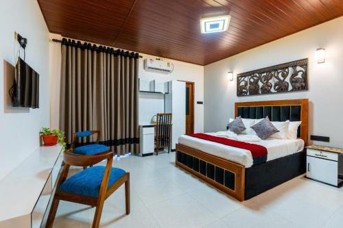 a bedroom with a bed and a desk and a chair at Golden stars hotel Dambulla in Dambulla