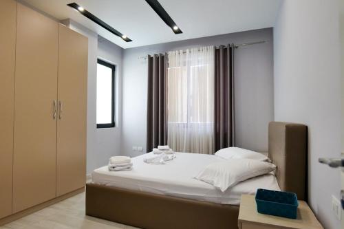 a bedroom with a large bed and a window at Olive Qerret in Golem